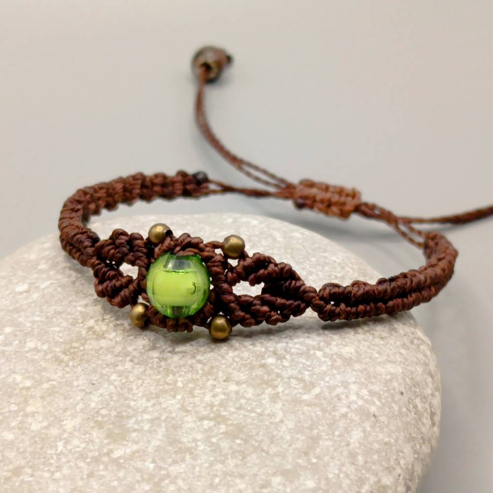 zierliches Makramee Armband in dunkelbraun mit einer grünen Acrylperle und bronzefarbenen Metallperlen Bild 1
