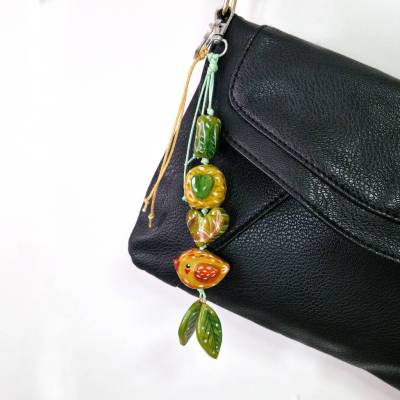 Handgefertigter Taschenanhänger mit Vogel- und Blättermotiv – natürliches Design, Unikat.
