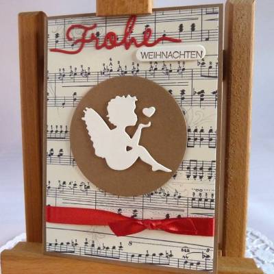 Weihnachtskarte mit Notenpapier, Himmelsbote und Satinband