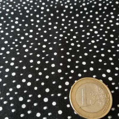 Schwarz mit kleinen, unregelmäßigen weissen Tupfen